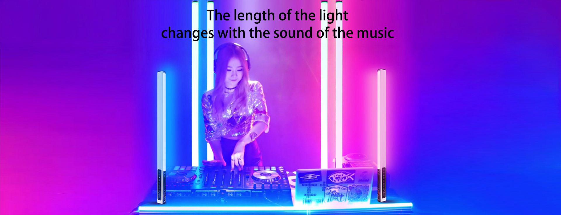 LUXCEO Mood 1 RGB LED atmosphere lights are reacting to the beat of the sound of the music. There is a DJ with headphones displayed with lights on either side of her.